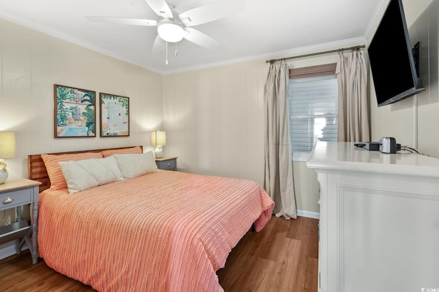 bedroom with crown molding, ceiling fan, and dark hardwood / wood-style flooring