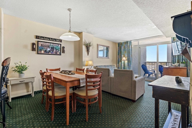 dining area with a wealth of natural light and dark colored carpet