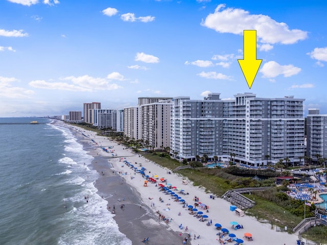 birds eye view of property featuring a beach view and a water view