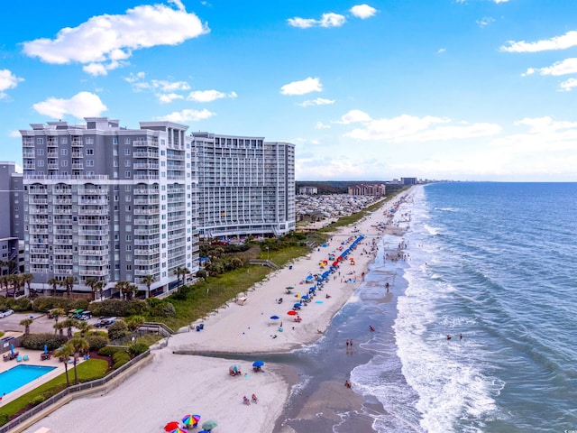 birds eye view of property with a water view and a view of the beach