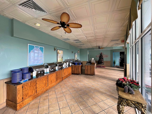 tiled office space featuring a healthy amount of sunlight and ceiling fan