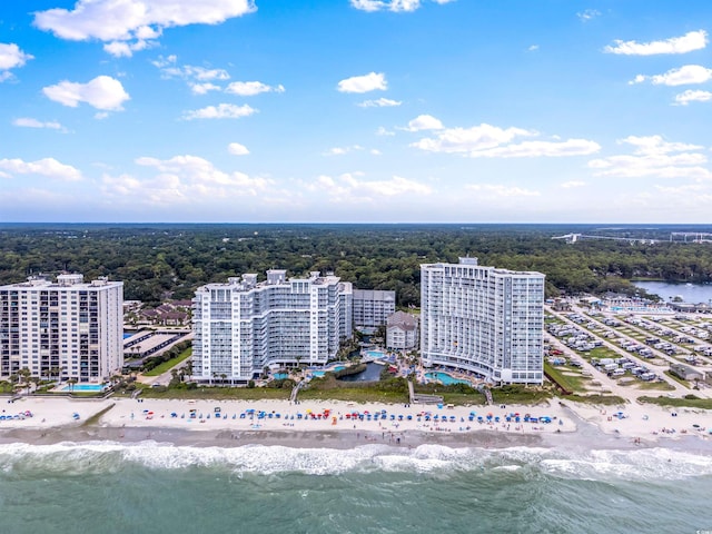 birds eye view of property featuring a water view and a view of the beach