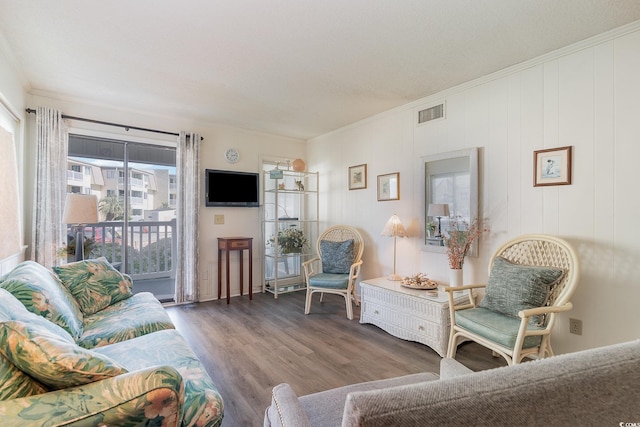 living room featuring hardwood / wood-style floors and ornamental molding