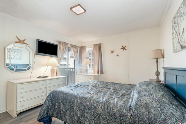 bedroom featuring crown molding and wood-type flooring