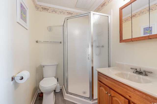 bathroom featuring vanity, crown molding, toilet, and walk in shower