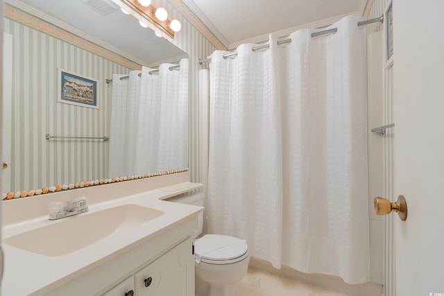 bathroom with vanity, crown molding, and toilet