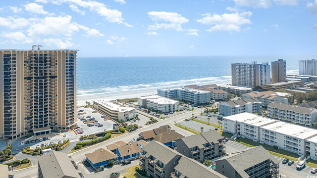 birds eye view of property with a water view and a view of the beach