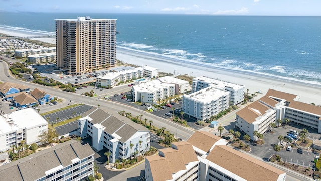 birds eye view of property featuring a water view and a view of the beach