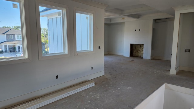 unfurnished living room featuring beam ceiling and a fireplace