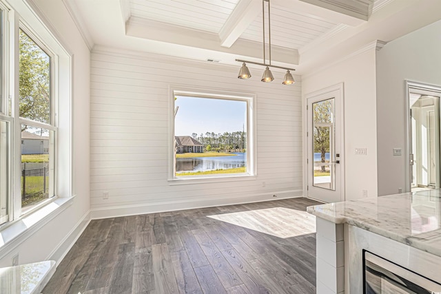 unfurnished dining area with wood walls, dark hardwood / wood-style flooring, beamed ceiling, a water view, and ornamental molding