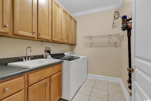 washroom featuring light tile floors, cabinets, crown molding, washing machine and dryer, and sink