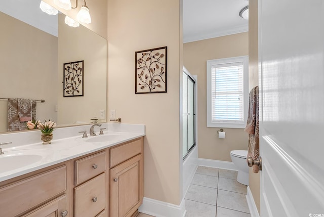 full bathroom featuring double sink vanity, tile floors, toilet, shower / bath combination with glass door, and ornamental molding