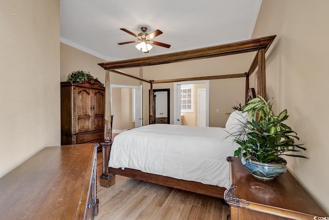 bedroom featuring light hardwood / wood-style flooring, ceiling fan, and crown molding