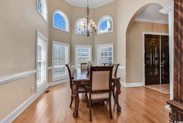 dining area featuring a notable chandelier, plenty of natural light, and light hardwood / wood-style floors