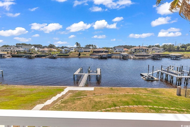 dock area with a yard and a water view