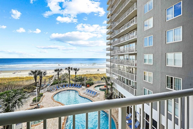 exterior space with a water view and a beach view