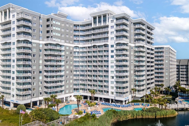 view of property featuring a community pool and a water view