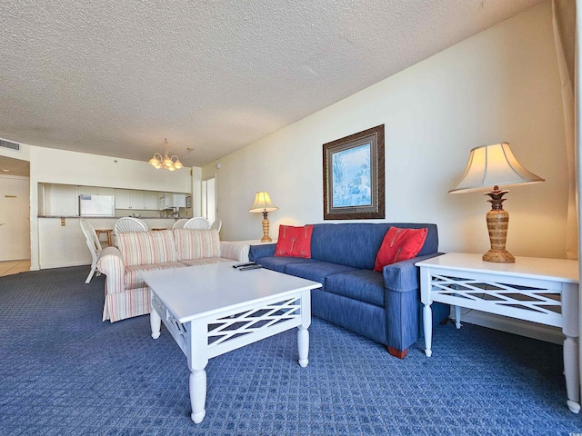 9820 Queensway Blvd Unit 501, Myrtle Beach, SC 29572 - living room featuring a chandelier, carpet, and a textured ceiling