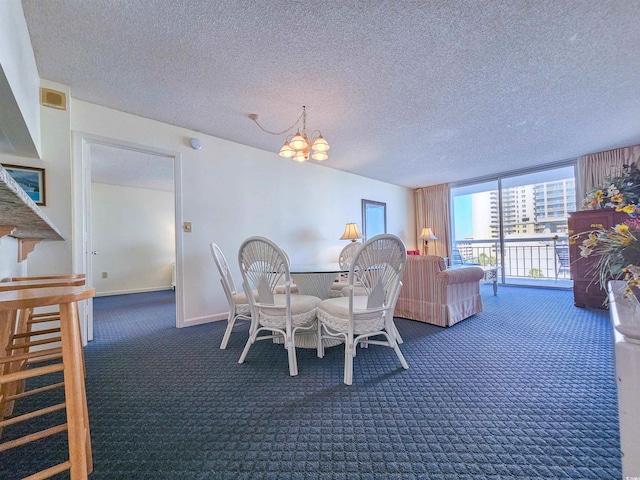 dining room featuring a textured ceiling, dark carpet, expansive windows, and a notable chandelier