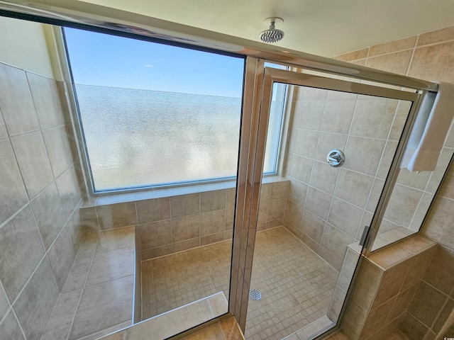 bathroom featuring tile walls and an enclosed shower