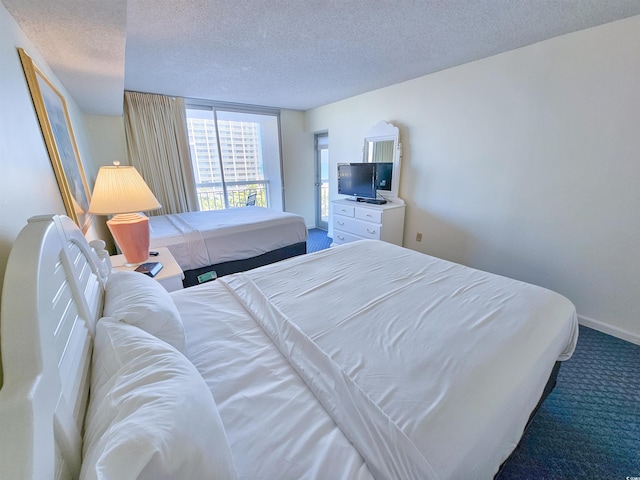 carpeted bedroom featuring a textured ceiling