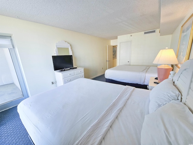 9820 Queensway Blvd Unit 501, Myrtle Beach, SC 29572 - carpeted bedroom featuring a textured ceiling