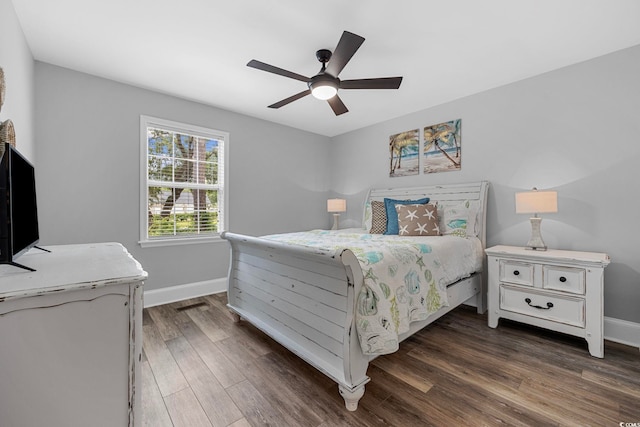 bedroom with ceiling fan and dark wood-type flooring