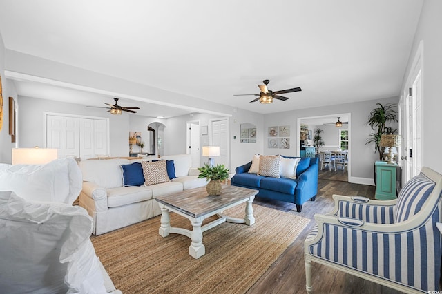 living room featuring dark hardwood / wood-style flooring and ceiling fan