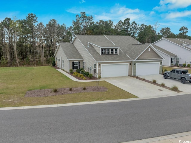 view of front of house featuring a front lawn and a garage