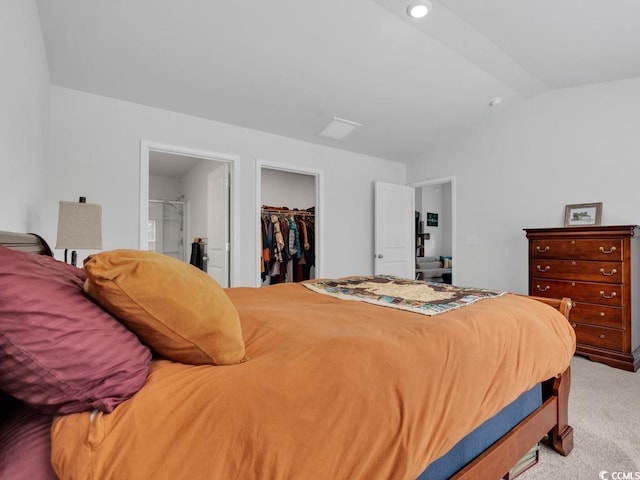 carpeted bedroom with a closet and a walk in closet