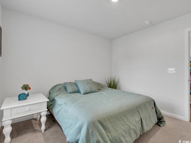 bedroom featuring light carpet