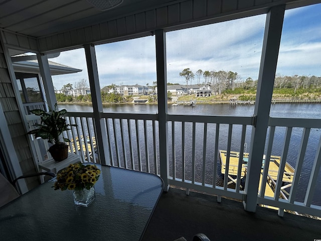 sunroom / solarium featuring a water view and a wealth of natural light