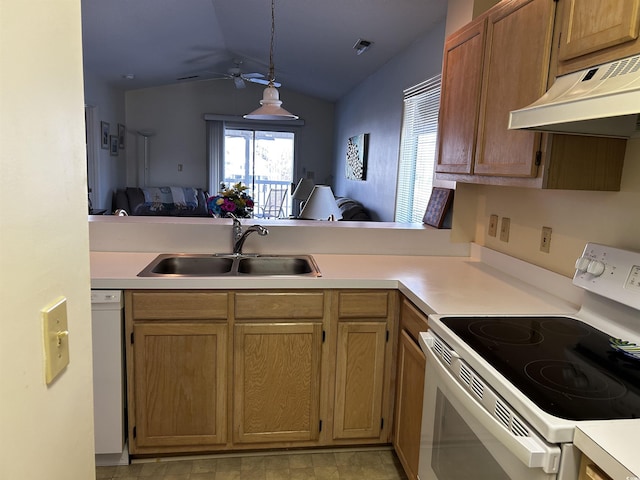 kitchen featuring sink, decorative light fixtures, vaulted ceiling, kitchen peninsula, and white appliances