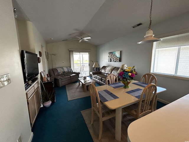 carpeted dining area with vaulted ceiling and ceiling fan