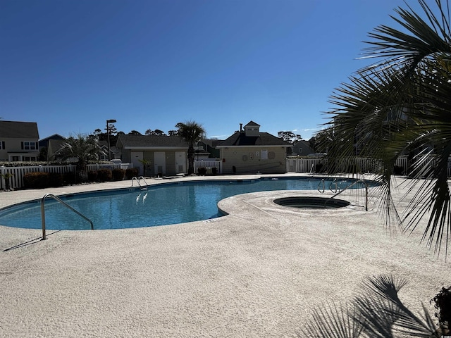 view of pool with a community hot tub and a patio