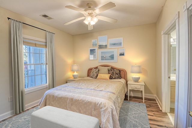 bedroom with ensuite bath, ceiling fan, and wood-type flooring