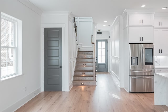 kitchen featuring plenty of natural light, stainless steel refrigerator with ice dispenser, and light hardwood / wood-style floors