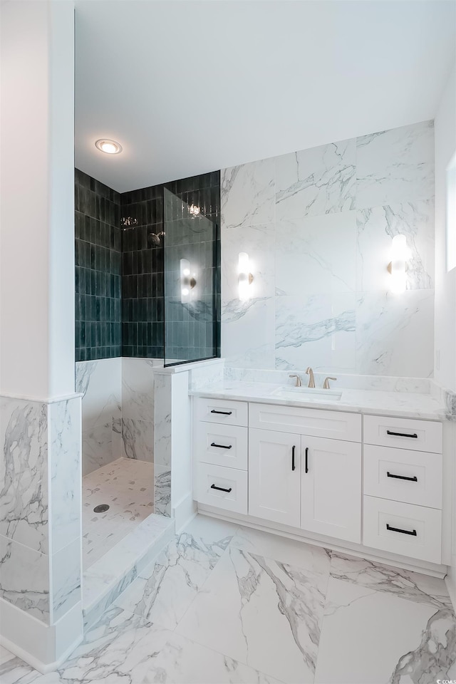 bathroom featuring tile walls, vanity, tiled shower, and tile flooring