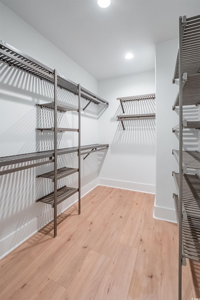 walk in closet with light wood-type flooring