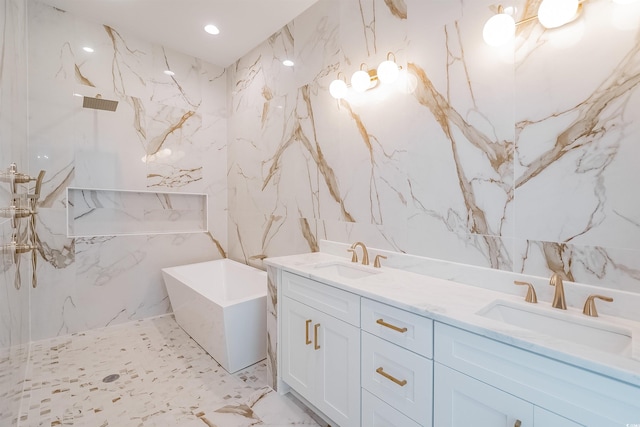 bathroom featuring a washtub, tile flooring, tile walls, and dual vanity