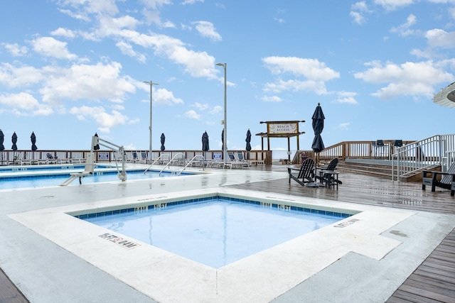 view of pool with a wooden deck