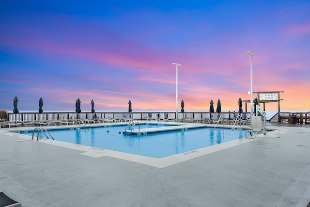 view of pool at dusk