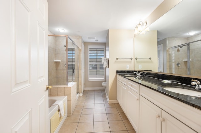 full bathroom with dual vanity, toilet, tile patterned floors, and separate shower and tub