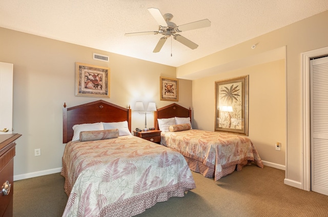 bedroom featuring carpet, a textured ceiling, and ceiling fan