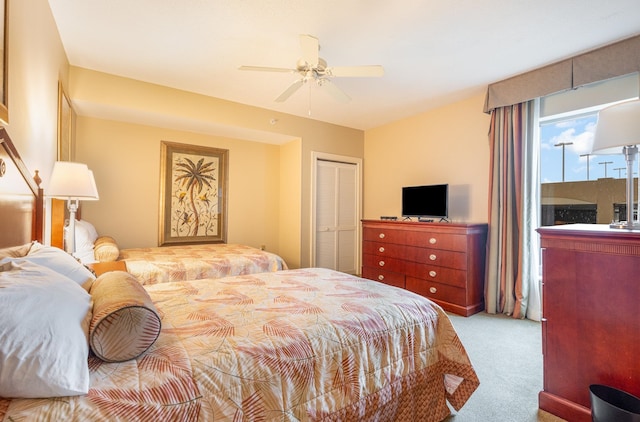 bedroom with light carpet, a closet, and ceiling fan