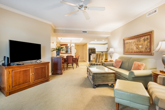 living room with ceiling fan with notable chandelier, light colored carpet, and ornamental molding