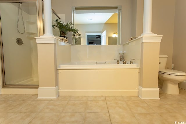 bathroom featuring toilet, decorative columns, and tile floors