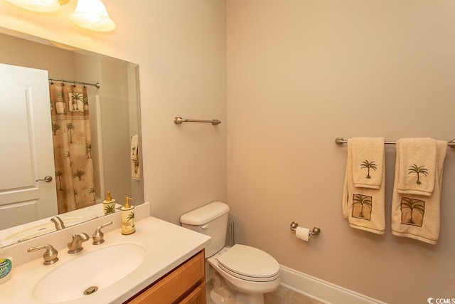 bathroom with tile floors, large vanity, and toilet