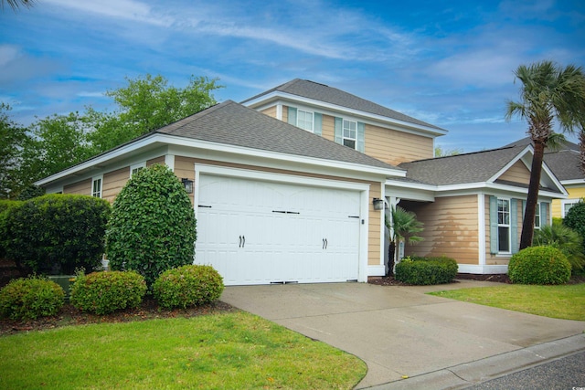 view of front facade with a garage and a front lawn