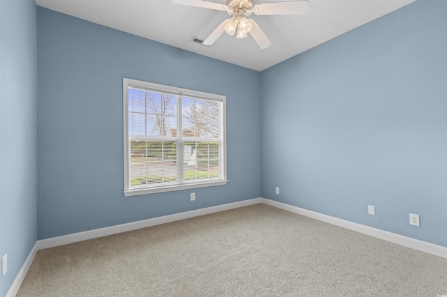 empty room featuring light colored carpet and ceiling fan